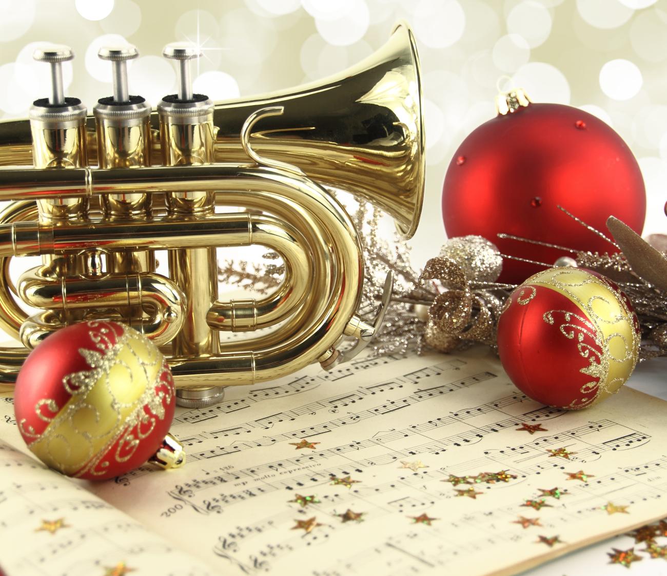 Trumpet with sheet music and holiday decorations